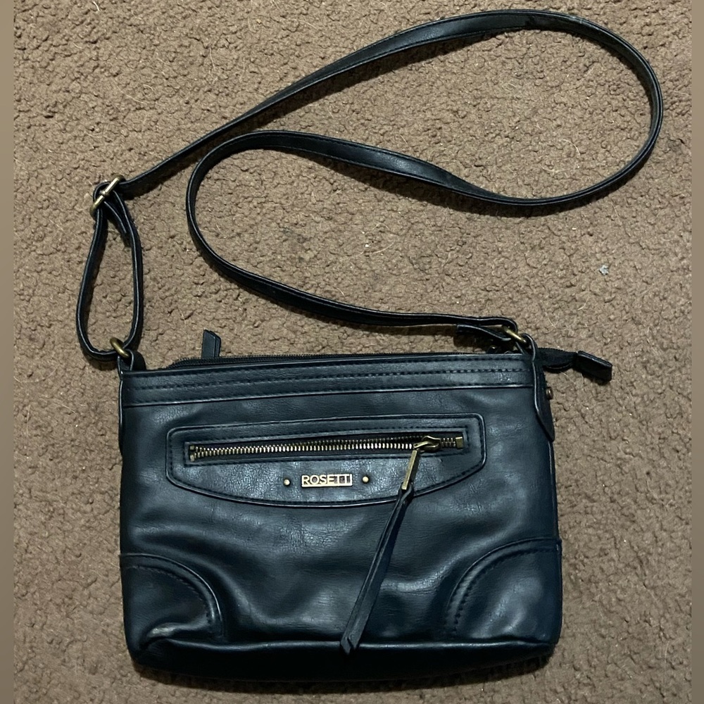 Black Rossetti crossbody purse. 3 zippered pouches inside and 2 outside.